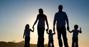 Family with young kids holding hands