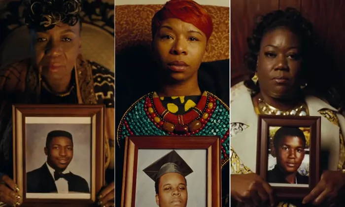 three Black mothers holding photos of their sons who were killed