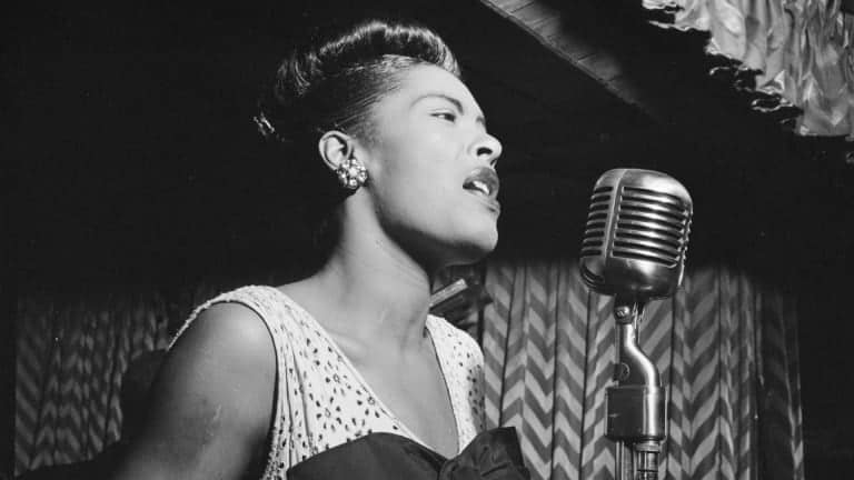 Billie Holiday in front of a microphone singing